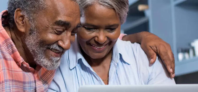 Two People Looking at a Laptop